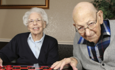 Foto van een oude man en vrouw die een spelletje spelen